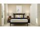 Bedroom featuring a bed with black frame, two side tables with lamps and a roller skate art piece above the bed at 3506 Kimbrough Dr, Lake Wales, FL 33859