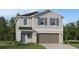Charming two-story home with grey siding, a 2-car garage, and well-manicured lawn at 3506 Kimbrough Dr, Lake Wales, FL 33859
