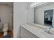 Bright bathroom featuring a large mirror, a spacious countertop, and a walk-in shower at 7040 Tamarind Dr, Lake Wales, FL 33898