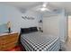 Comfortable bedroom with a black and white checkered bedspread, neutral walls, and a spacious closet at 7040 Tamarind Dr, Lake Wales, FL 33898