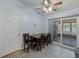 Cozy dining area featuring a ceiling fan, table with seating for four, and sliding glass doors to an enclosed patio at 7040 Tamarind Dr, Lake Wales, FL 33898