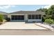 Charming home featuring a screened in porch, wide driveway, and manicured landscaping at 7040 Tamarind Dr, Lake Wales, FL 33898