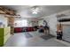 Spacious garage with workbench, pegboard, ceiling fan, and ample storage space at 7040 Tamarind Dr, Lake Wales, FL 33898