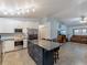 Open kitchen with stainless steel appliances, granite countertops, and island with seating at 7040 Tamarind Dr, Lake Wales, FL 33898