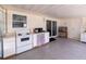 Bright eat-in kitchen featuring stainless steel appliances and ample cabinet space, with a sliding door at 7040 Tamarind Dr, Lake Wales, FL 33898