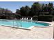 Community pool featuring a covered sitting area and plenty of lounge chairs at 7040 Tamarind Dr, Lake Wales, FL 33898
