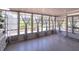 Bright sunroom with tile flooring and many windows with curtains, letting in natural light and offering a peaceful atmosphere at 7040 Tamarind Dr, Lake Wales, FL 33898