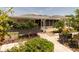 Inviting backyard showcasing a covered patio, well-manicured landscaping, and picturesque outdoor living spaces at 7040 Tamarind Dr, Lake Wales, FL 33898