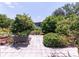 Beautifully landscaped yard with lush greenery, paved pathways, and decorative plantings, creating a tranquil outdoor space at 7040 Tamarind Dr, Lake Wales, FL 33898