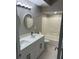 Bathroom with double sinks, modern fixtures, granite countertop, large mirror, and shower and tub at 12020 Villanova Dr # 107, Orlando, FL 32837