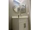 Bathroom vanity with white countertop, cabinet, modern sink, and decorative round mirrors at 12020 Villanova Dr # 107, Orlando, FL 32837