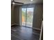 Bedroom features dark hardwood flooring, sliding glass doors to balcony, and a ceiling fan at 12020 Villanova Dr # 107, Orlando, FL 32837