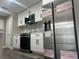 An updated kitchen features white cabinets, stainless steel appliances, and a decorative backsplash at 12020 Villanova Dr # 107, Orlando, FL 32837