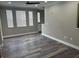 A living room has waterproof flooring, multiple windows, and a ceiling fan for comfort at 12020 Villanova Dr # 107, Orlando, FL 32837