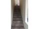 A modern stairway features waterproof flooring that leads to the upper levels of the home at 12020 Villanova Dr # 107, Orlando, FL 32837