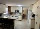 Bright kitchen featuring white appliances, ample counter space, and a breakfast bar at 1230 Jasmine Rd, Apopka, FL 32703