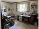Bright office with a large wooden desk, comfortable chair, and window with sheer curtains at 1230 Jasmine Rd, Apopka, FL 32703