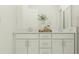 Well-lit bathroom featuring a double vanity with granite counters and decorative accessories at 4572 Ochos Rios Pl, Kissimmee, FL 34758