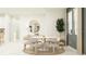 Elegant dining room with a modern table, comfortable seating, and stylish decor at 4572 Ochos Rios Pl, Kissimmee, FL 34758