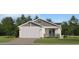 Charming single-Gathering home with a two-car garage, stone accents, and a covered front porch at 4572 Ochos Rios Pl, Kissimmee, FL 34758