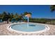 Community splash pad featuring mushroom fountain, surrounded by lounge chairs and lush greenery at 4572 Ochos Rios Pl, Kissimmee, FL 34758