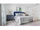 Bedroom featuring a comfortable bed with soft bedding, stylish decor, and a modern feel at 5657 Portico Pl, Kissimmee, FL 34758