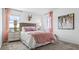 Bright bedroom featuring a soft bed, stylish decor, and views of the outdoors at 5657 Portico Pl, Kissimmee, FL 34758