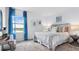 Bright bedroom featuring a comfortable bed, soft carpeting, and a large window with a view at 5657 Portico Pl, Kissimmee, FL 34758