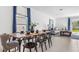 Bright dining area with a wooden table, seating for six, and elegant blue curtains at 5657 Portico Pl, Kissimmee, FL 34758
