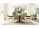 Elegant dining area with a large window and a modern table with seating for six at 1283 Dora Parc Ln, Mount Dora, FL 32757