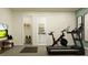 Home gym featuring modern exercise equipment, with an adjacent bathroom at 1283 Dora Parc Ln, Mount Dora, FL 32757