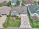 Charming home with a well-manicured lawn, mature landscaping, and a unique patterned driveway at 1709 Latta Ct, The Villages, FL 32162