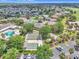 Community amenities with swimming pool, shuffleboard, and bocce ball surrounded by lush trees and landscaping at 1709 Latta Ct, The Villages, FL 32162