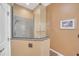 Glass-enclosed shower with tiled walls and granite accents, complemented by neutral tones at 1709 Latta Ct, The Villages, FL 32162