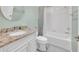 Bathroom featuring a granite countertop, white vanity, and a shower-tub combination at 1709 Latta Ct, The Villages, FL 32162