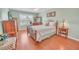 Comfortable bedroom with wood floors, shuttered windows and neutral paint scheme at 1709 Latta Ct, The Villages, FL 32162