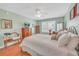 Well-lit bedroom featuring wood floors, shuttered windows and a neutral paint scheme at 1709 Latta Ct, The Villages, FL 32162