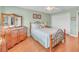 Bedroom featuring wood floors, double closet and a neutral color scheme at 1709 Latta Ct, The Villages, FL 32162