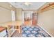 Bonus room showing access to the dining area, wood floors, and decorative area rug at 1709 Latta Ct, The Villages, FL 32162