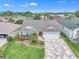 Well-maintained home with lush landscaping, charming flowerbeds, and a unique patterned driveway at 1709 Latta Ct, The Villages, FL 32162