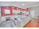 Bright, open kitchen design with white cabinetry, workspace, marble countertops at 1709 Latta Ct, The Villages, FL 32162