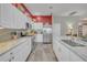 Bright kitchen featuring white cabinetry, stainless steel appliances, and an expansive kitchen island at 1709 Latta Ct, The Villages, FL 32162