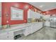 Well-lit kitchen features a built-in workspace, offering seamless connectivity and practical functionality at 1709 Latta Ct, The Villages, FL 32162
