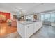 Bright kitchen island with a built-in dishwasher seamlessly integrates with living and dining spaces at 1709 Latta Ct, The Villages, FL 32162