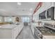 Well-equipped kitchen showcases modern stainless steel appliances and plenty of counterspace at 1709 Latta Ct, The Villages, FL 32162
