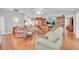 Cozy living room showcases plush seating, rich wood floors, and built-in display shelves for added charm at 1709 Latta Ct, The Villages, FL 32162