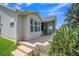 A patio is located outside of the home with beautiful landscaping in the flowerbeds and a screened-in porch at 1709 Latta Ct, The Villages, FL 32162