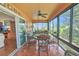 Inviting sunroom with plenty of natural light, tile floors, and comfortable furnishings at 1709 Latta Ct, The Villages, FL 32162