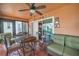 Light-filled sunroom with comfortable seating, tile flooring, and scenic outdoor views at 1709 Latta Ct, The Villages, FL 32162