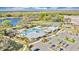 Community aerial view showcases a sparkling pool, tennis courts, clubhouse, and convenient parking in a well-maintained setting at 1894 Clear Sky Dr, Kissimmee, FL 34744